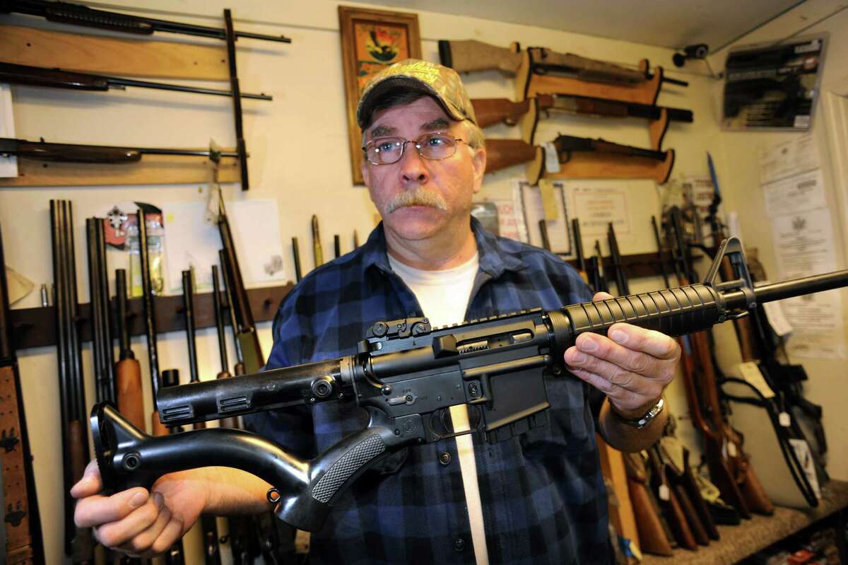Shop owner Rich Sehlmeyer holds an AR-15 assault-style rifle with a compliant stock on Saturday, May 25, 2013, at The Gun Shop in Lake Luzerne, N.Y. (Cindy Schultz / Times Union)