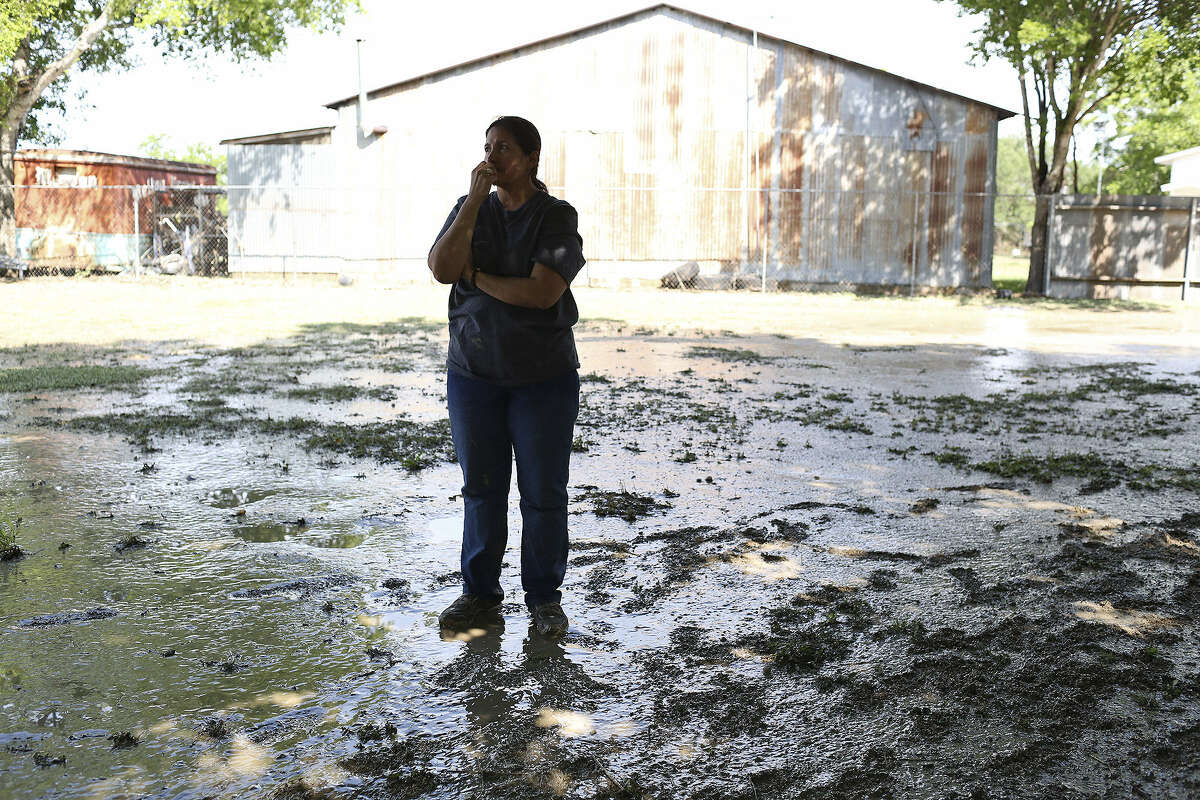 Olivarez surveys the damage the high waters did to her home. Olivarez grew up in the home and lives there now with her family.
