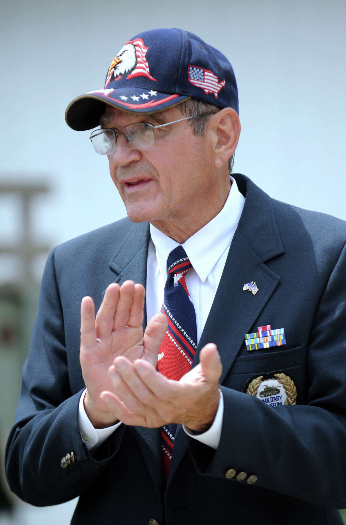 John Valluzzo, of Ridgefield, founder and president of the Southern New England Military Museum in Danbury, applauds speakers at a ceremony that brought pieces of steel from the World Trade Center to the museum's display. Photo taken Tuesday, June 28, 2011.