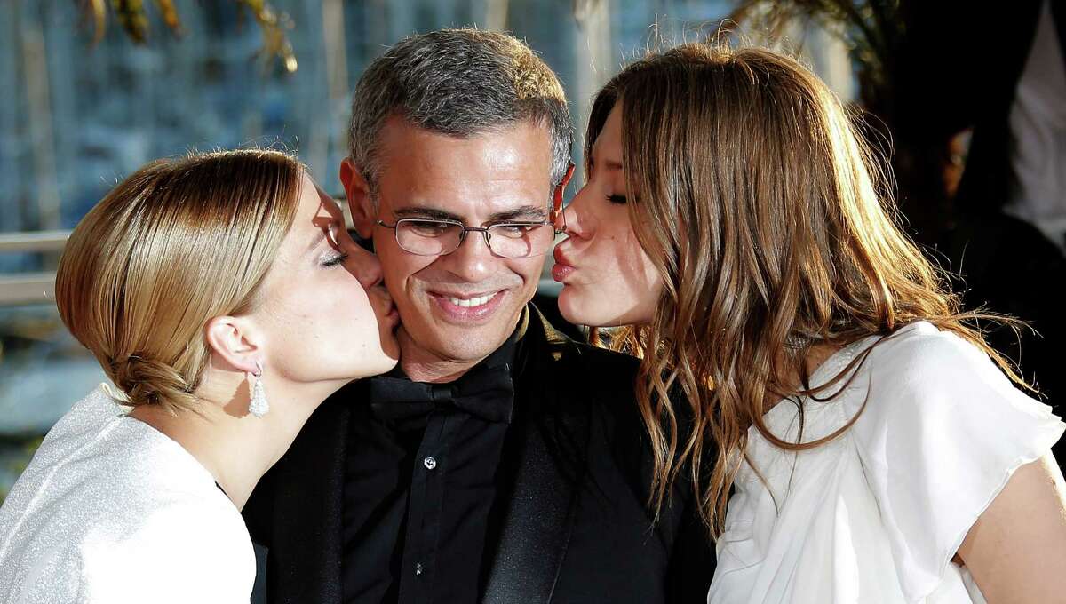 Actress Lea Seydoux, left, director Abdellatif Kechiche, centre, and Adele Exarchopoulos pose with the Palme d'Or award for the film La Vie D'Adele during a photo call after an awards ceremony at the 66th international film festival, in Cannes, southern France, Sunday, May 26, 2013. (AP Photo/Lionel Cironneau)