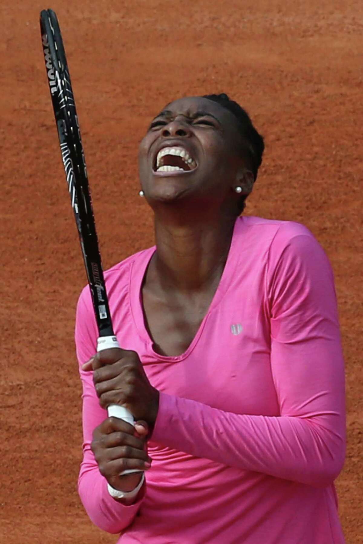 Venus Williams of the U.S. screams after missing a return a return against Poland's Urszula Radwanska in their first round match of the French Open tennis tournament, at Roland Garros stadium in Paris, Sunday, May 26, 2013. (AP Photo/Michel Euler)
