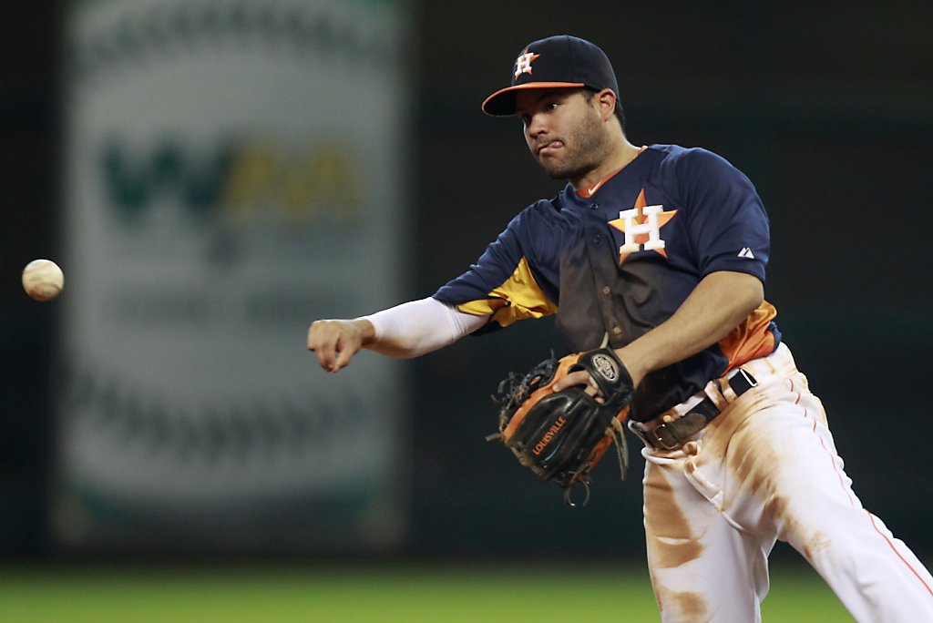 Houston Astros second baseman Jose Altuve fields a ground ball hit by  Oakland Athletics' Chris Young in the first inning during a baseball game,  Sunday, May 26, 2013, in Houston. (AP Photo/Patric