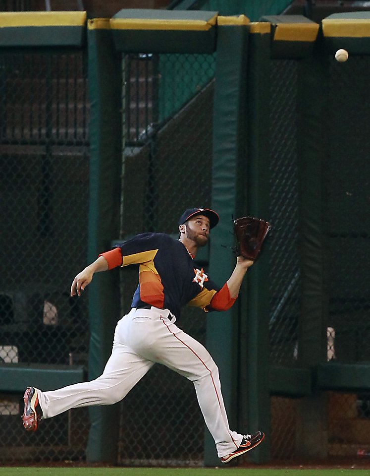 Houston Astros second baseman Jose Altuve fields a ground ball hit by  Oakland Athletics' Chris Young in the first inning during a baseball game,  Sunday, May 26, 2013, in Houston. (AP Photo/Patric