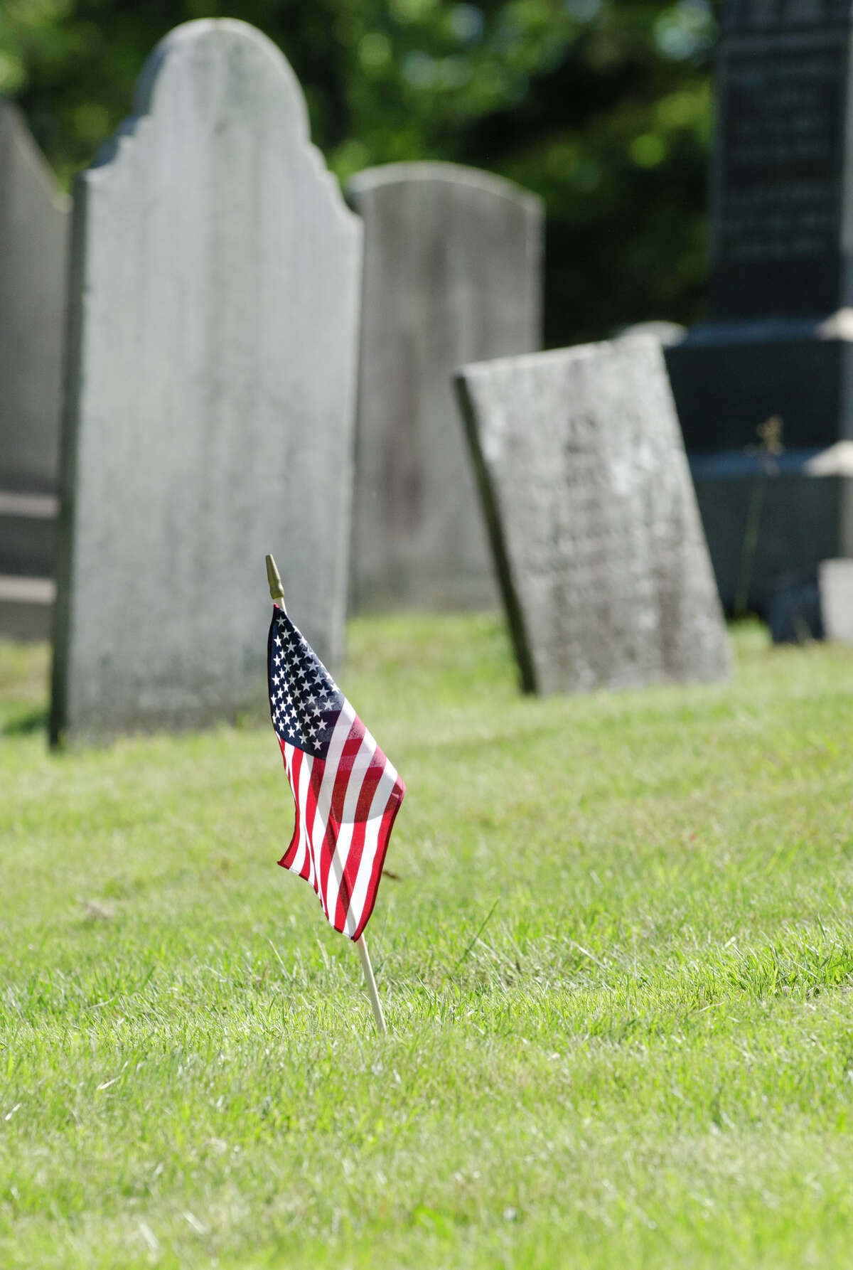 A small American Flag is planted in the ground of the First Congregational Church cemetery in Old Greenwich on Monday, May 27, 2013.
