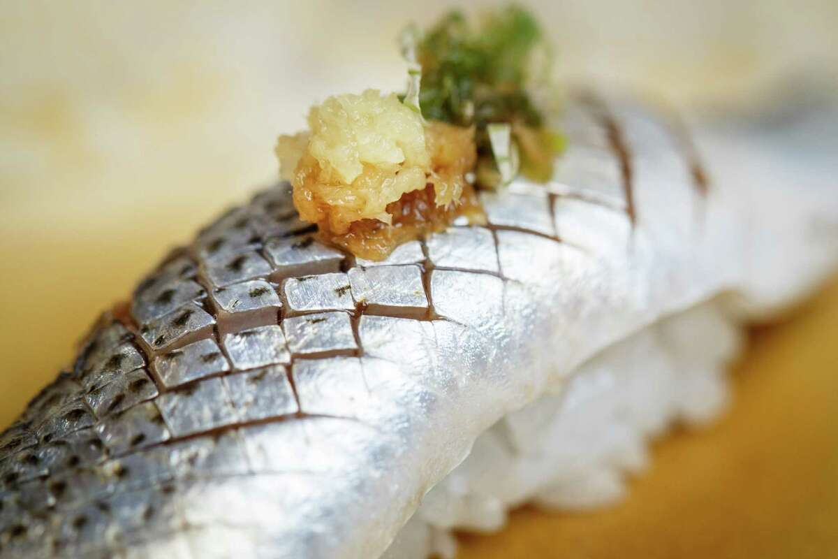Kohada, a gizzard shad served with fresh grated ginger and green onions, looks like an exotic mosaic.