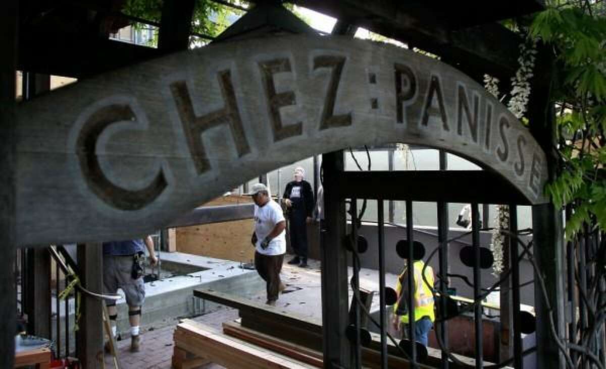 Workers bolt a three ton A-frame to the foundation as it is put into place on the front porch of Chez Panisse in Berkeley, Calif. on Tues. April 30, 2013. Photo: Michael Macor/The Chronicle