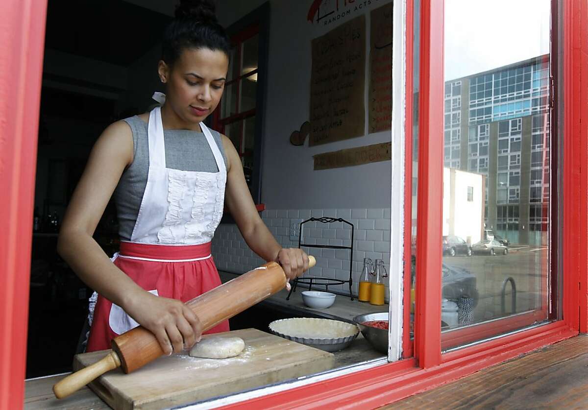 Jaynelle St. Jean prepares a strawberry rhubarb pie behind the takeout window of her PieTisserie bakery in Oakland, Calif. on Tuesday, May 7, 2013.
