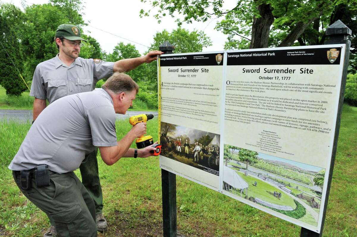 Saratoga National Historical Park maintenance staff members Charles Koffman, left, and Jeff Wells erect an historic marker at the park's newly acquired satellite property along Rt. 4, in the Town of Saratoga Wednesday May 29, 2013. The site is where British Gen. Burgoyne surrendered his sword to Gen. Gates at America's first major victory in the Revolutionary War. (John Carl D'Annibale / Times Union)