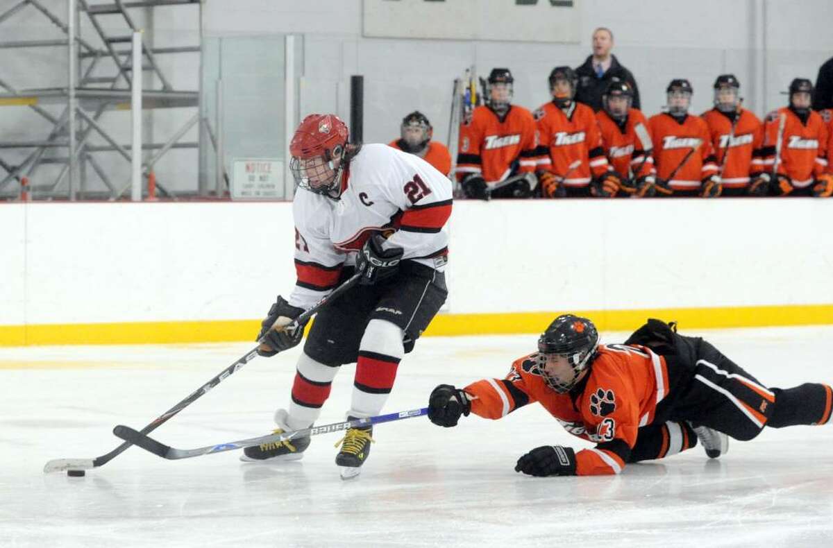 Greenwich captain Ryan Kelly moves beyond Ridgefield's Duncan Morrissey as the Greenwich High School Cardinals host the Ridgefield High School Tigers in a boys hockey game at Dorothy Hamill Tuesday evening, January 12, 2010.