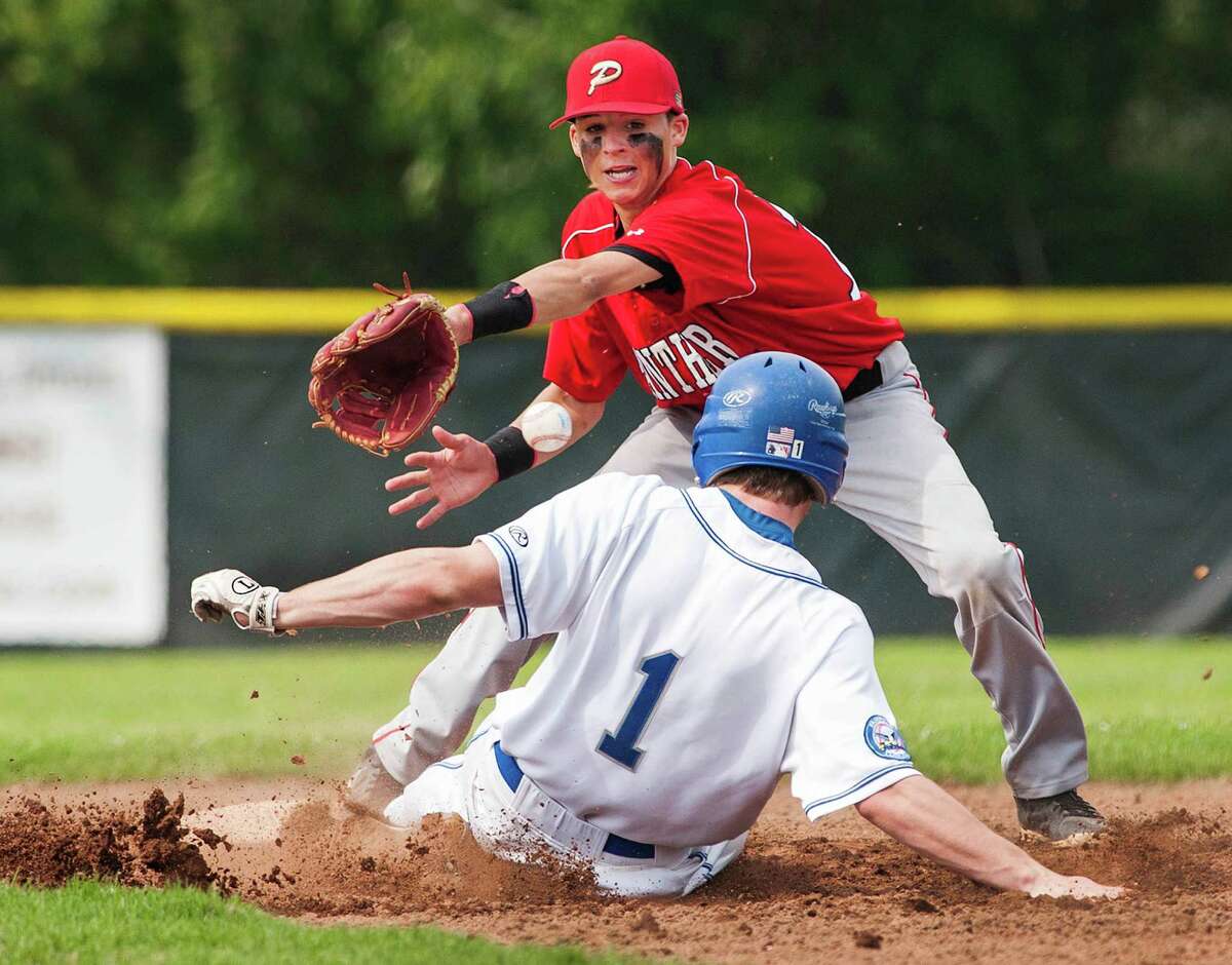 Fairfield Ludlowe high school's Michael Arman slides safely into second as Pomperaug high school shortstop Nate Zappone can't apply the tag in time during a first round game of the CIAC class LL baseball tournament played at Kiwanis field, Fairfield, CT on Wednesday May 29th, 2013.