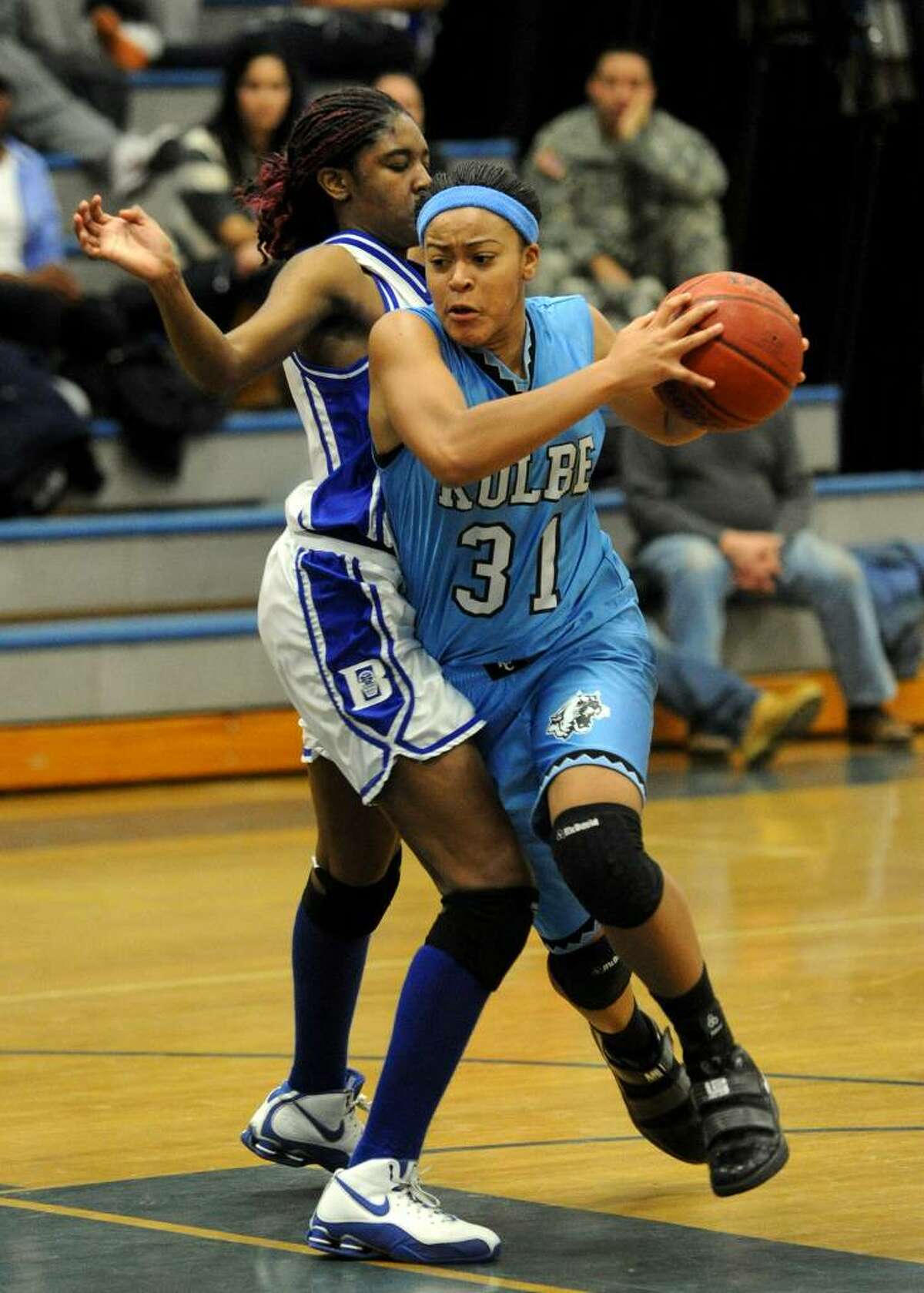 Kolbe's #31 Cherelle Moore tries to drive past Bunnell's #21 Shaqura Palmer, during girls basketball action in Stratford, Conn. on Tuesday Jan. 12, 2010.
