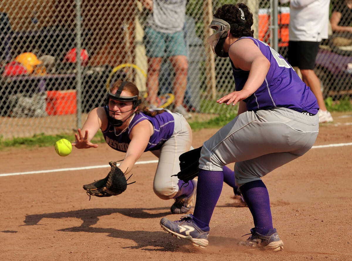 Westhill third baseman Tammy Wise dives unsuccessfully for the ball as Sadie Apfel, right, looks on during their second round Class LL state softball championship game against West Haven at Westhill High School in Stamford on Thursday, May 30, 2013. West Haven won, 5-0.