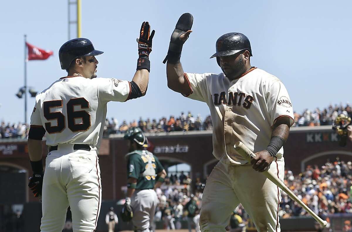 San Francisco Giants' Pablo Sandoval, right, is congratulated by teammate Andres Torres (56) after scoring on Brandon Belt's two-run double against the Oakland Athletics during the sixth inning of a baseball game in San Francisco, Thursday, May 30, 2013. (AP Photo/Jeff Chiu)
