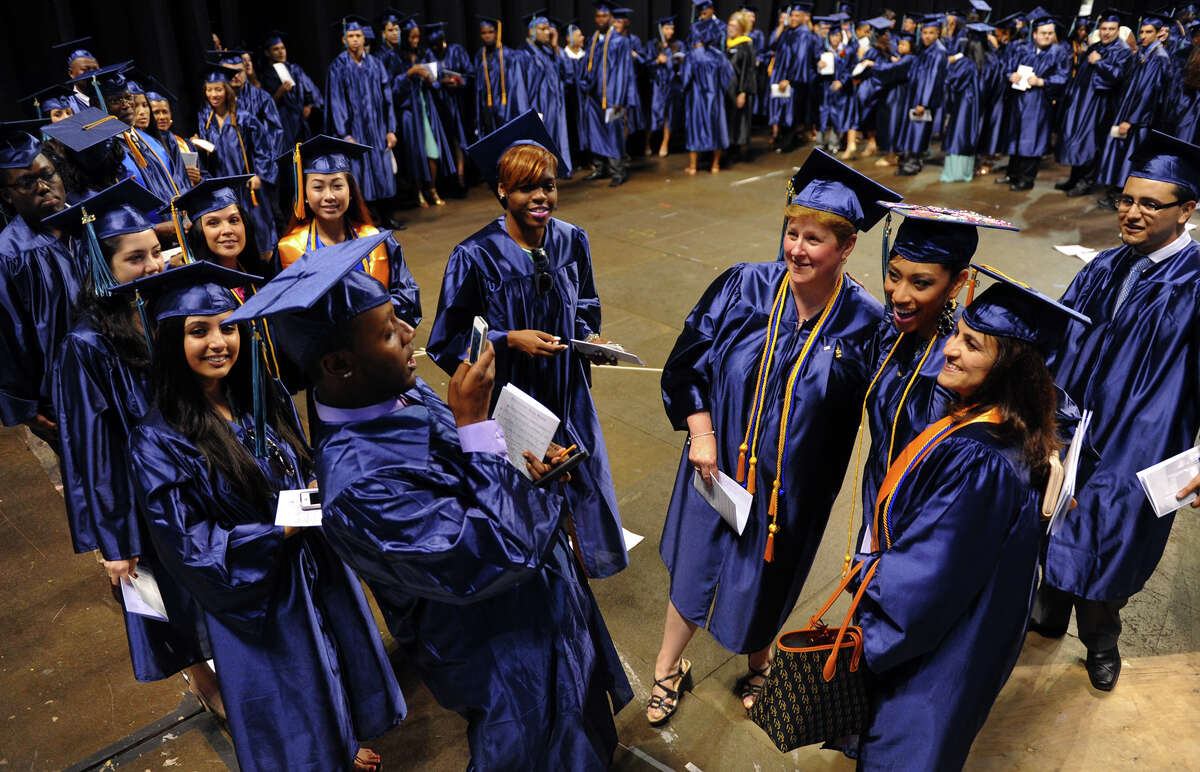 Graduate David Hewitt uses a cell phone to snap some pictures of fellow graduates before the start of Housatonic Community College's 46th Commencement at the Webster Bank Arena in Bridgeport, Conn. on Thursday May 30, 2013.