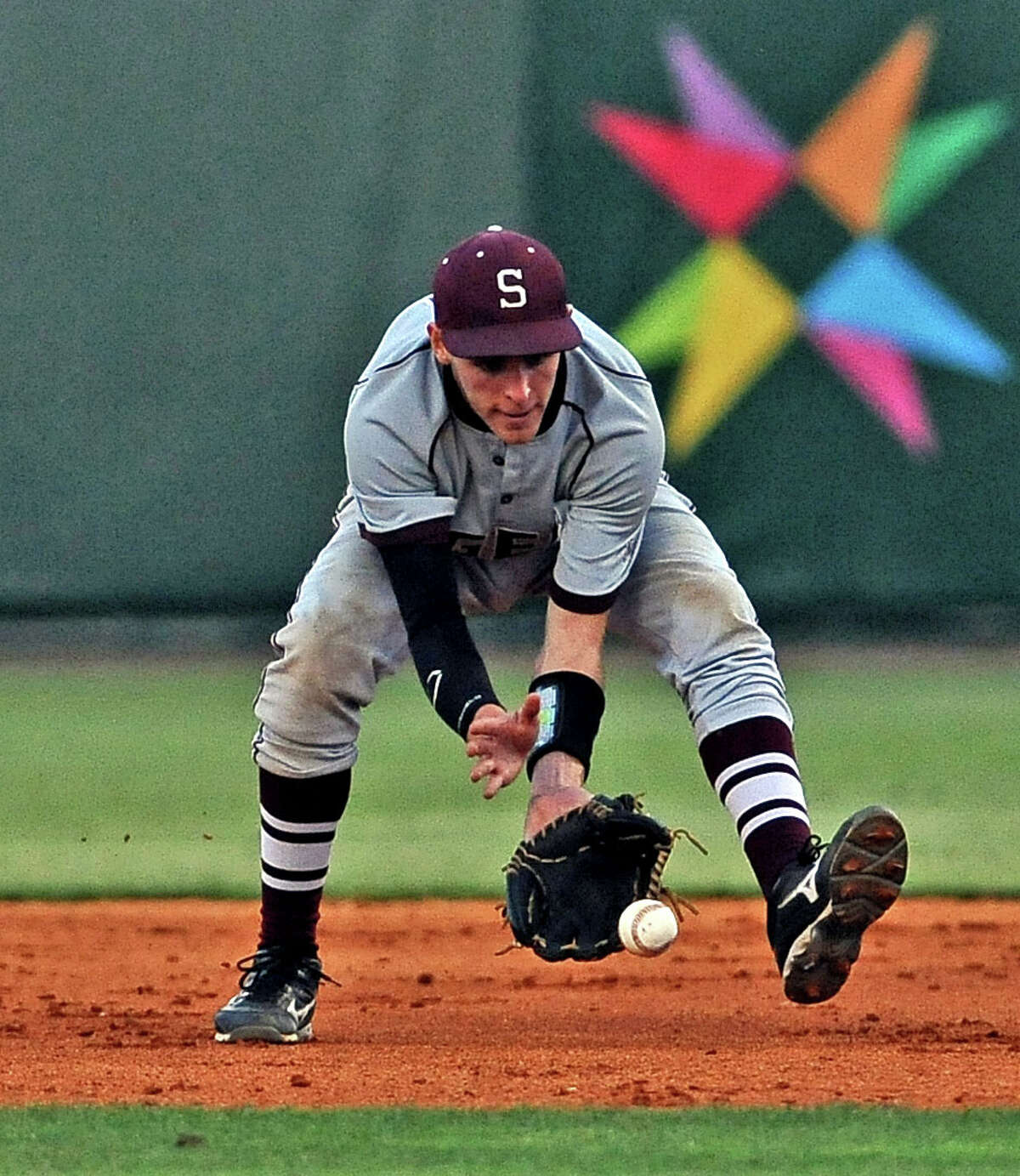Silsbee second baseman Jordan Gore, #5, fields a ground ball during the Silsbee High School district baseball game against Diboll High School at the University of Houston on Thursday, May 30, 2013. Photo taken: Randy Edwards/The Enterprise