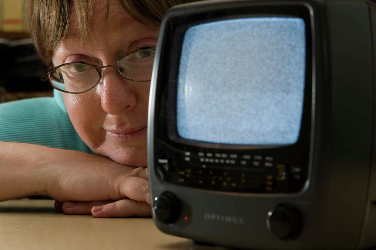 Donna Clanton poses for a portrait with her battery powered analog television. ( Brett Coomer / Chronicle )