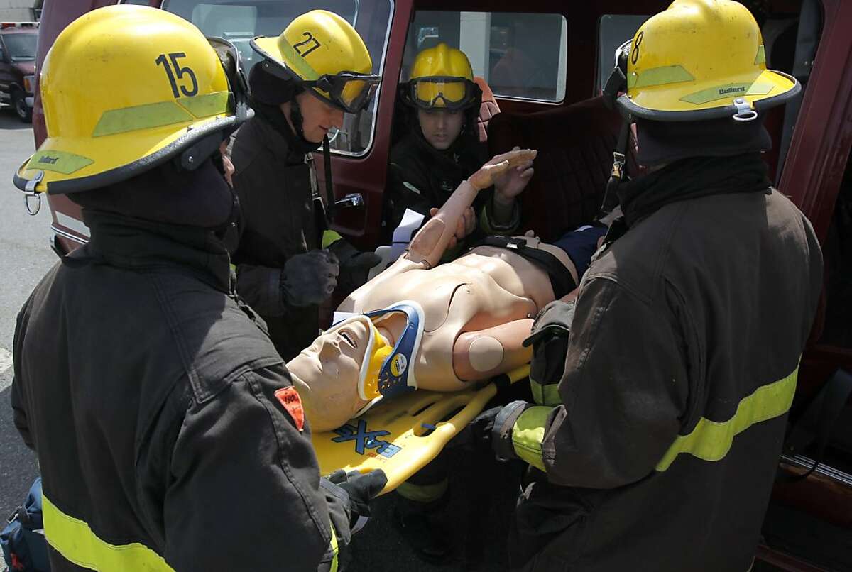 Students rescue a victim from a simulated auto accident at a City College firefighter training class on Treasure Island in San Francisco, Calif. on Saturday, April 13, 2013. The future of the popular Firefighter Academy program is in jeopardy if City College loses its accreditation.