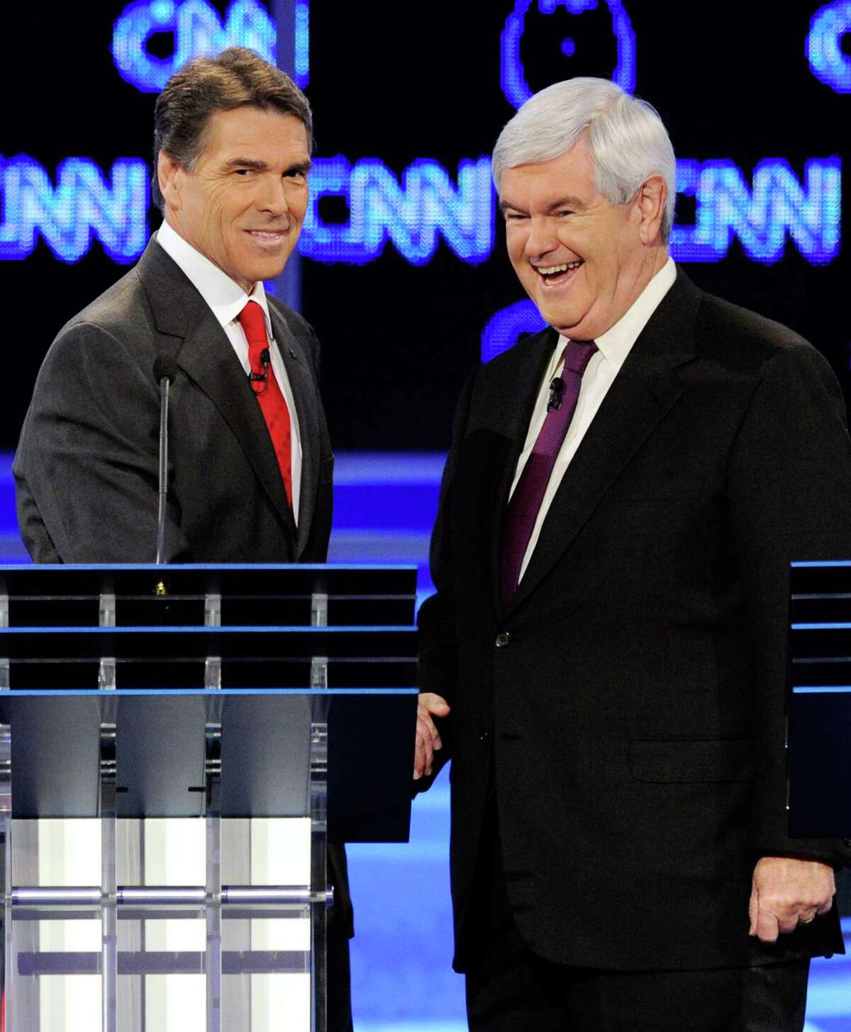 Rick Perry and former Speaker of the House Newt Gingrich shake hands after the Republican presidential debate airing on CNN, October 18, 2011 in Las Vegas.