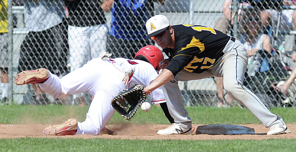 At left, Ricky Okazaki of Greenwich just gets back to first on a pick-off play as Amity first baseman Justin Ashworth takes the throw during the bottom of the first inning of the Class LL baseball quarterfinal game between Greenwich High School and Amity High School at Greenwich, June 1, 2013. Okazaki was the only Greenwich player to reach base and did so on an error. Amity defeated Greenwich 6-0 as Amity pitcher Michael Concato threw a no hitter.