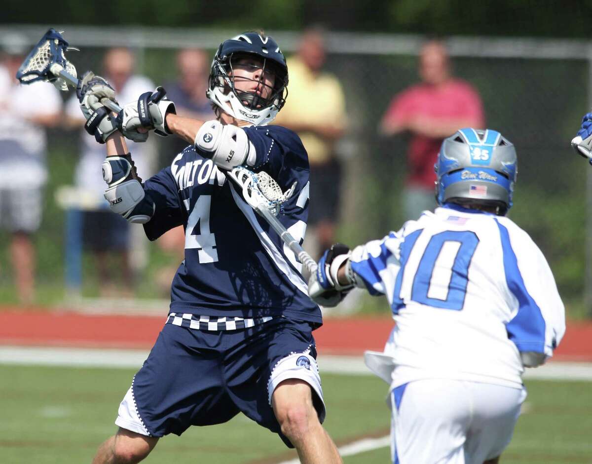 Wilton middie Michael Burns fires a shot on goal during quarterfinal CIAC lacrosse action against Darien. Wilton avenged an early season loss, topping the Blue Wave 7-6. © J. Gregory Raymond for The Advocate