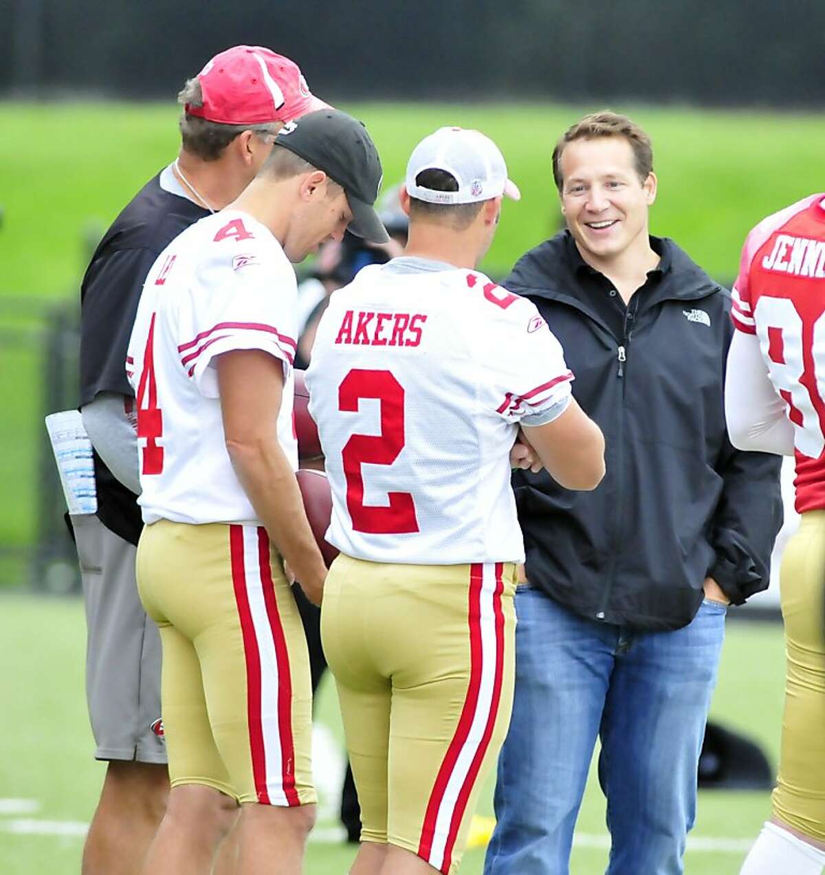 YOUNGSTOWN, OHIO - SEPTEMBER 29, 2011: Former head coach Eric Mangini of the New York Jets and Cleveland Browns smiles while talking with kicker David Akers #2 and punter Andy Lee #4 of the San Francisco 49ers during practice at Stambaugh Stadium at Youngstown State University in Youngstown, Ohio on September 29, 2011. (Photo by David Dermer/Diamond Images/Getty Images)