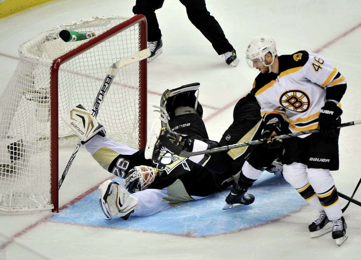 The Bruins' David Krejci beats Tomas Vokoun, whose Pens teammates hit the post six times.