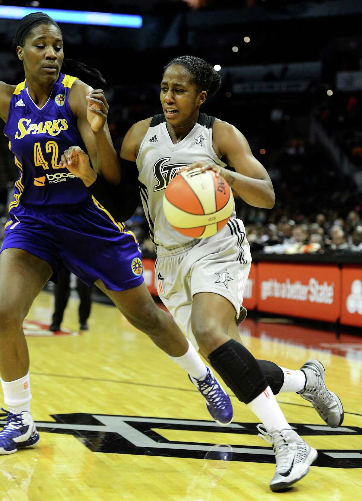 San Antonio Silver Stars' Shenise Johnson (42) drives to the basket around Los Angeles Sparks' Jantel Lavender (42) during a WNBA game at the AT&T Center. John Albright / Special to the Express-News
