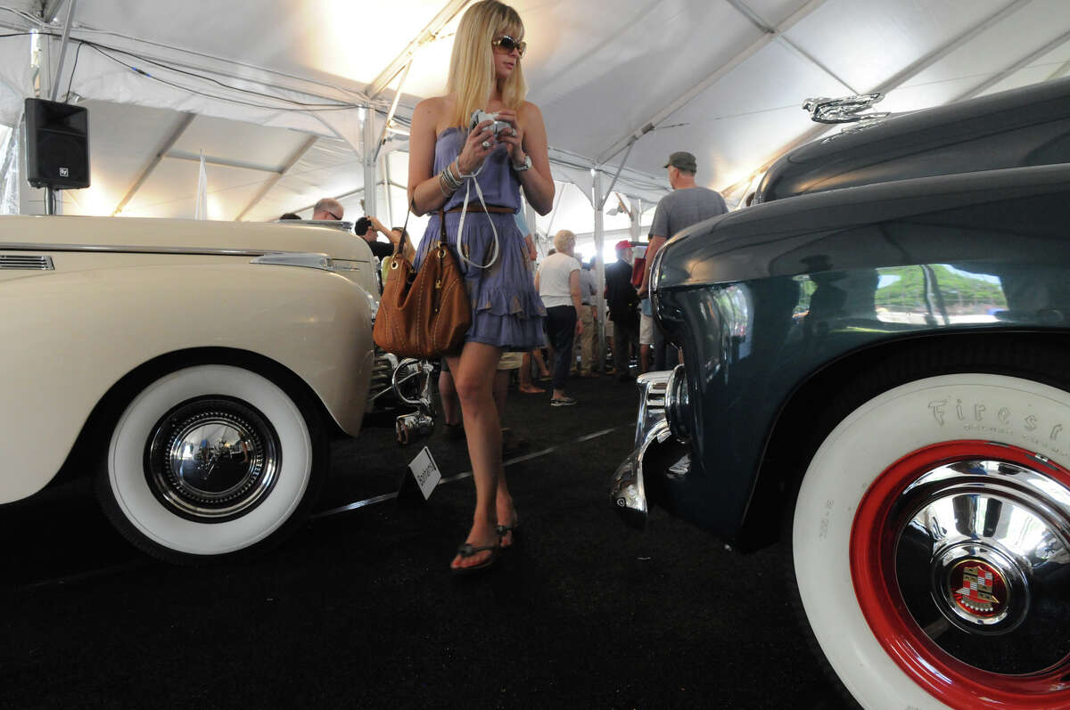 Rachael Teutul fis framed by a 1940 Chrysler New Yorker Highlander and a 1941 Cadillac Series 62 before they are auctioned as the British based auction house Bonhams hosts the annual auction of rare and classic cars at the Greenwich Concours d'Elegance at Roger Sherman Baldwin Park in Greenwich, Conn., June 2, 2013.