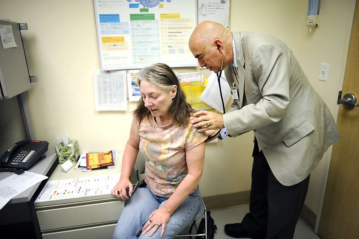 Jenelle Prins(L) of Emeryville, who suffers chronic pain due to spinal injuries incurred in a car accident and later an airplane accident, is examined by Dr. Kornfeld during a check up visit in the pain clinic at Highland General Hospital in Oakland, CA on Tuesday May 28th, 2013.