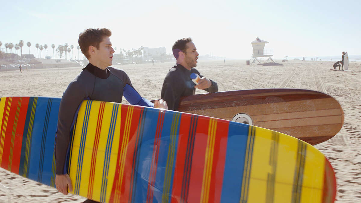 Mike Warren (Aaron Tveit, left) and Paul Briggs (Daniel Sunjata) take to the surf in "Graceland."