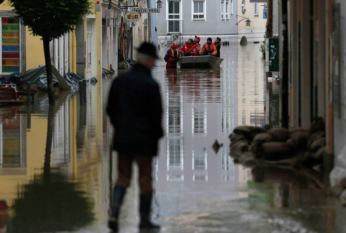 Red cross teams use boats to evacuate people after river Danube flooded the old town of Passau, southern Germany, on Tuesday, June 4, 2013. Raging waters from three rivers have flooded large parts of the southeast German city following days of heavy rainfall in central Europe. Floodwaters in Passau are receding from the highest level seen in more than five centuries but cities downstream are bracing themselves as swollen rivers sweep through southeastern Germany. At least eight people have been reported dead and nine missing in the floods in Germany, Austria, Switzerland and the Czech Republic. (AP Photo/Matthias Schrader)