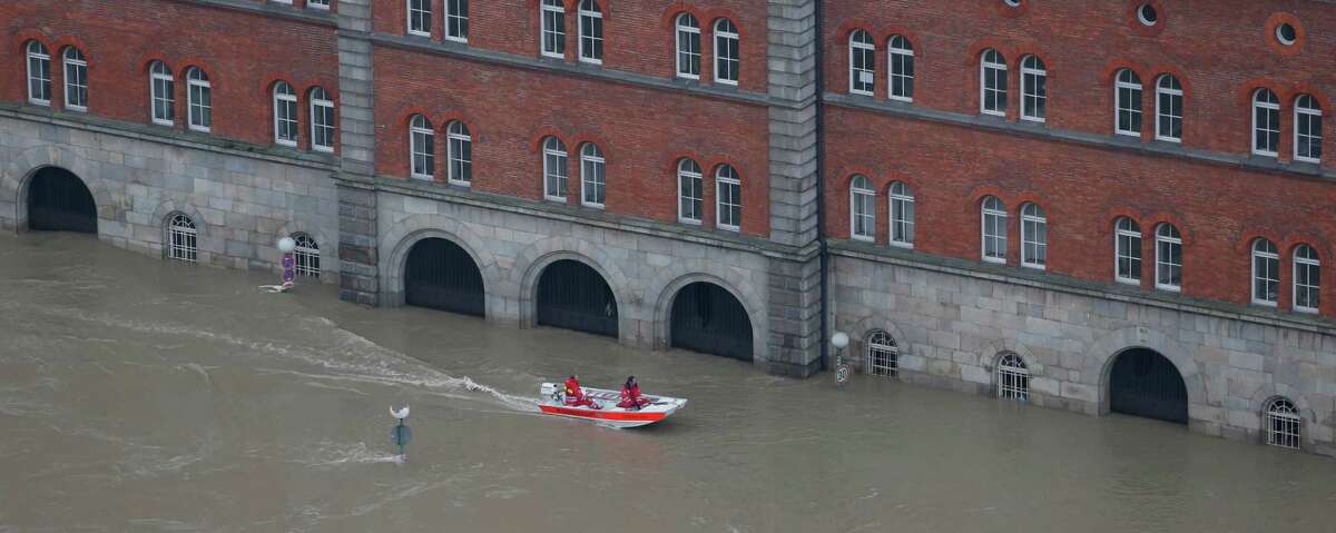 Members of the red cross make their way in a boat through the flooded old centre of Passau, southern Germany, on Tuesday, June 4, 2013. Raging waters from three rivers have flooded large parts of the southeast German city following days of heavy rainfall in central Europe. Floodwaters in Passau are receding from the highest level seen in more than five centuries but cities downstream are bracing themselves as swollen rivers sweep through southeastern Germany. At least eight people have been reported dead and nine missing in the floods in Germany, Austria, Switzerland and the Czech Republic. (AP Photo/Matthias Schrader)