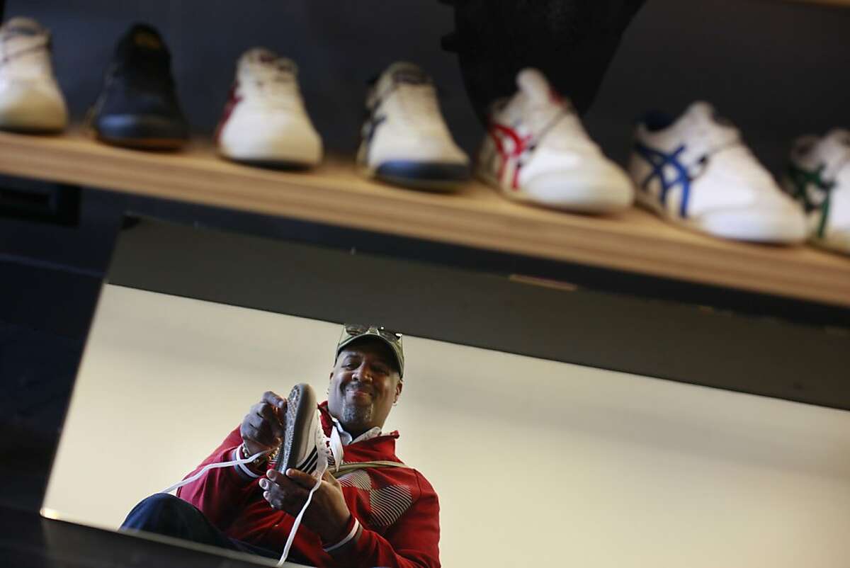 David Gantt of Baltimore, Maryland tries on a pair of shoes while shopping at Undefeated on Hayes Street on Tuesday, June 4, 2013 in San Francisco, Calif.