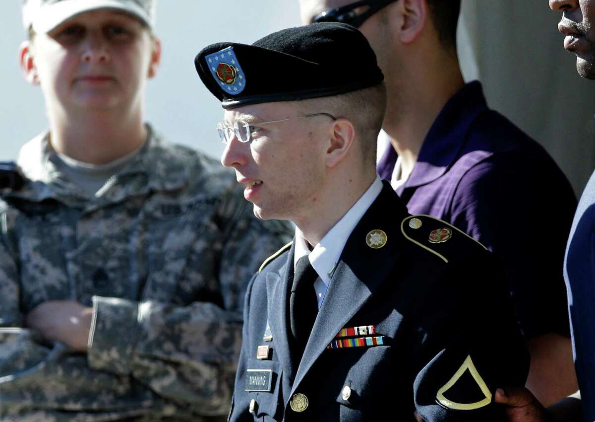 Army Pfc. Bradley Manning, front, is escorted out of a courthouse in Fort Meade, Md., Tuesday, June 4, 2013, after the second day of his court martial. Manning is charged with indirectly aiding the enemy by sending troves of classified material to WikiLeaks. He faces up to life in prison. (AP Photo/Patrick Semansky)