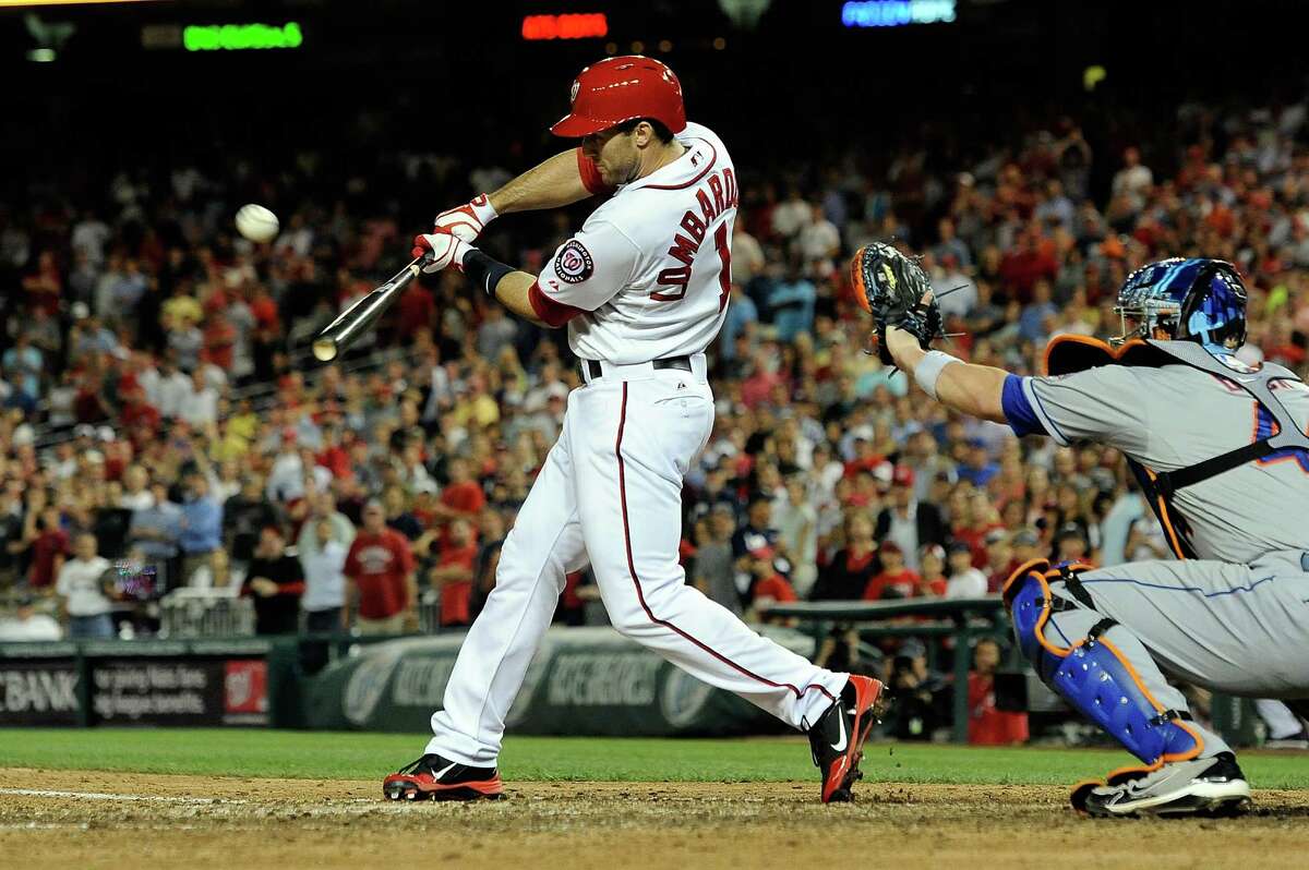 WASHINGTON, DC - JUNE 04: Stephen Lombardozzi #1 of the Washington Nationals hits a game winning sacrifice fly scoring Adam LaRoche #25 in the ninth inning during a game against the New York Mets at Nationals Park on June 4, 2013 in Washington, DC. The Nationals defeated the Mets 3-2. (Photo by Patrick McDermott/Getty Images)