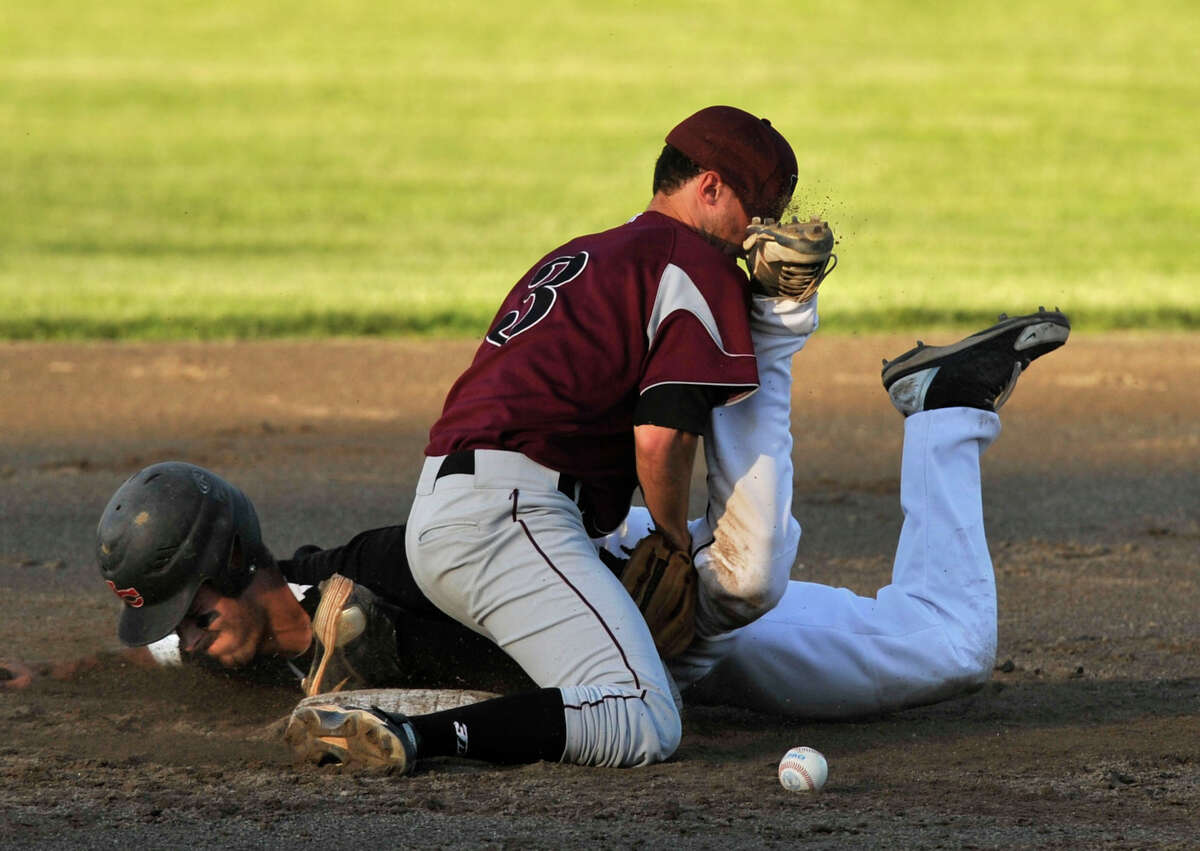 New Canaan's Andrew Casali slides safely into second while colliding with North Haven's Jaycen Torello during their Class L semifinal baseball game at Palmer Field Stadium in Middletown on Tuesday, June 4, 2013. New Canaan won, 5-1.