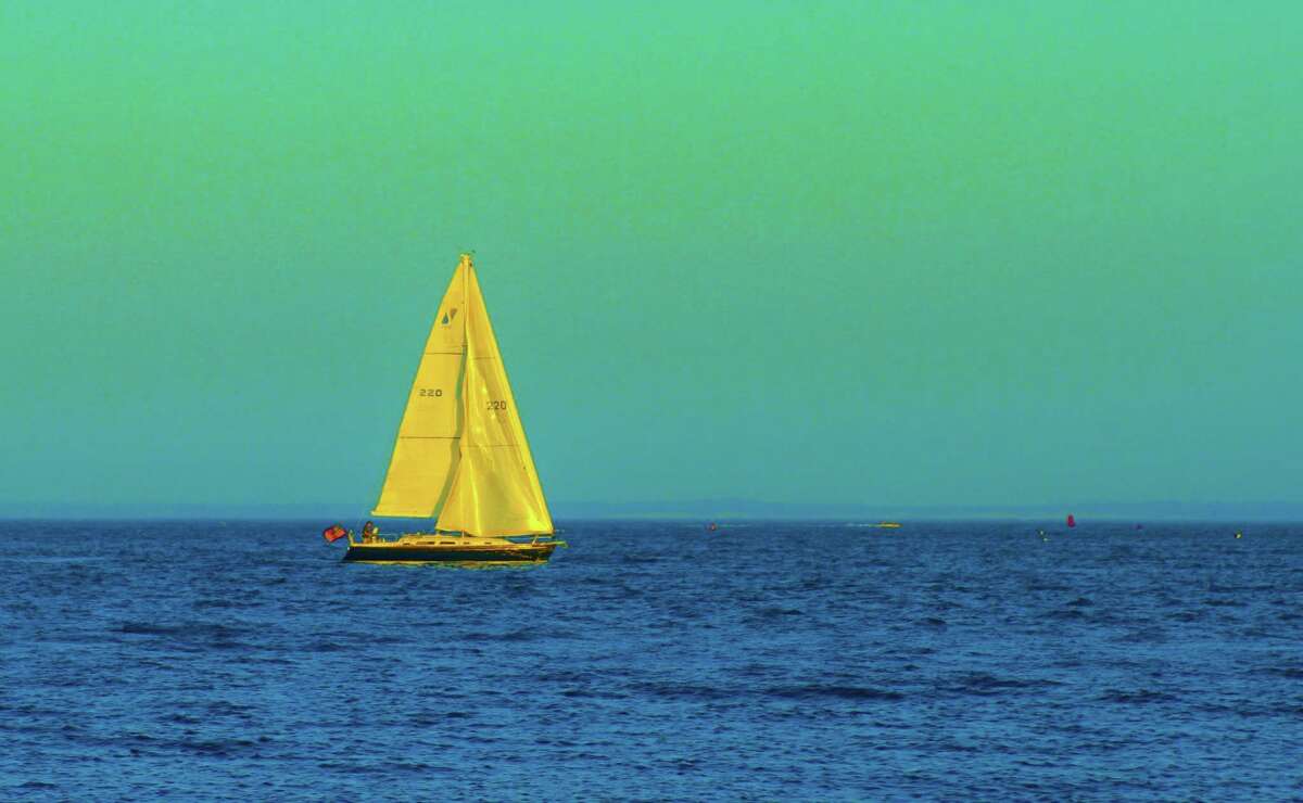 SUNDAY EVENING SAIL A sailboat passing Compo Beach is outlined against a pale, Sunday evening sky. The soothing scene marking the end of the weekend was captured by Dayle Brownstein.