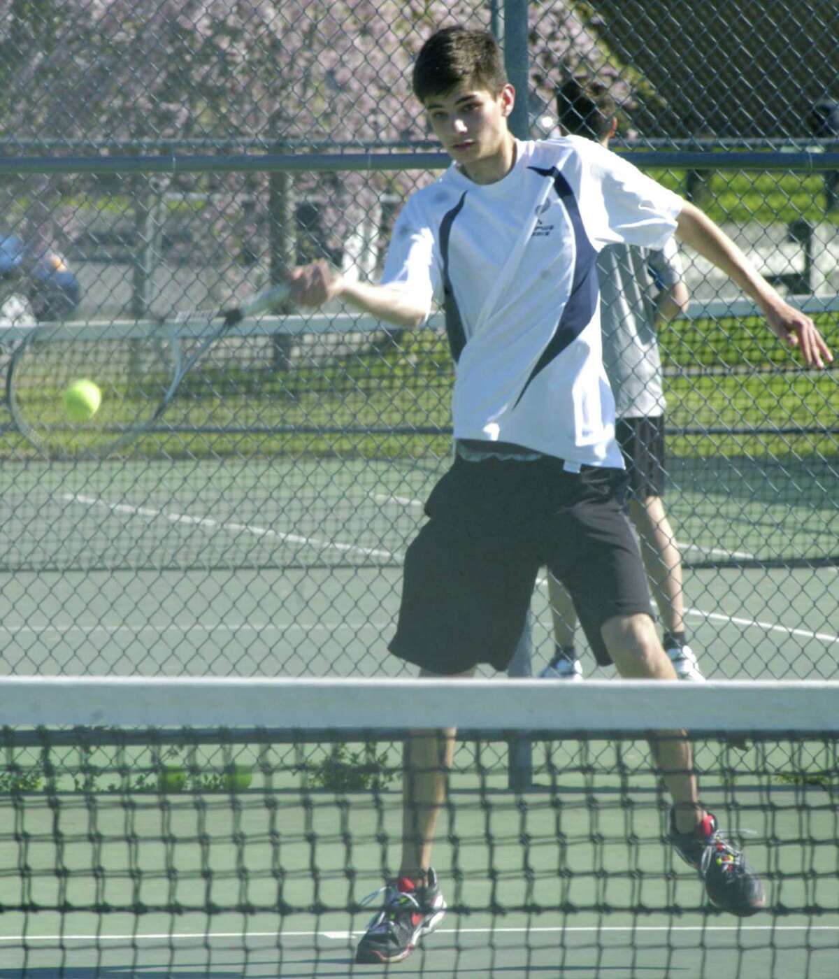 The Spartans' Kirby Peters employs his impressive reach to retrieve a rival's shot for Shepaug Valley High School boys' tennis. May 2013