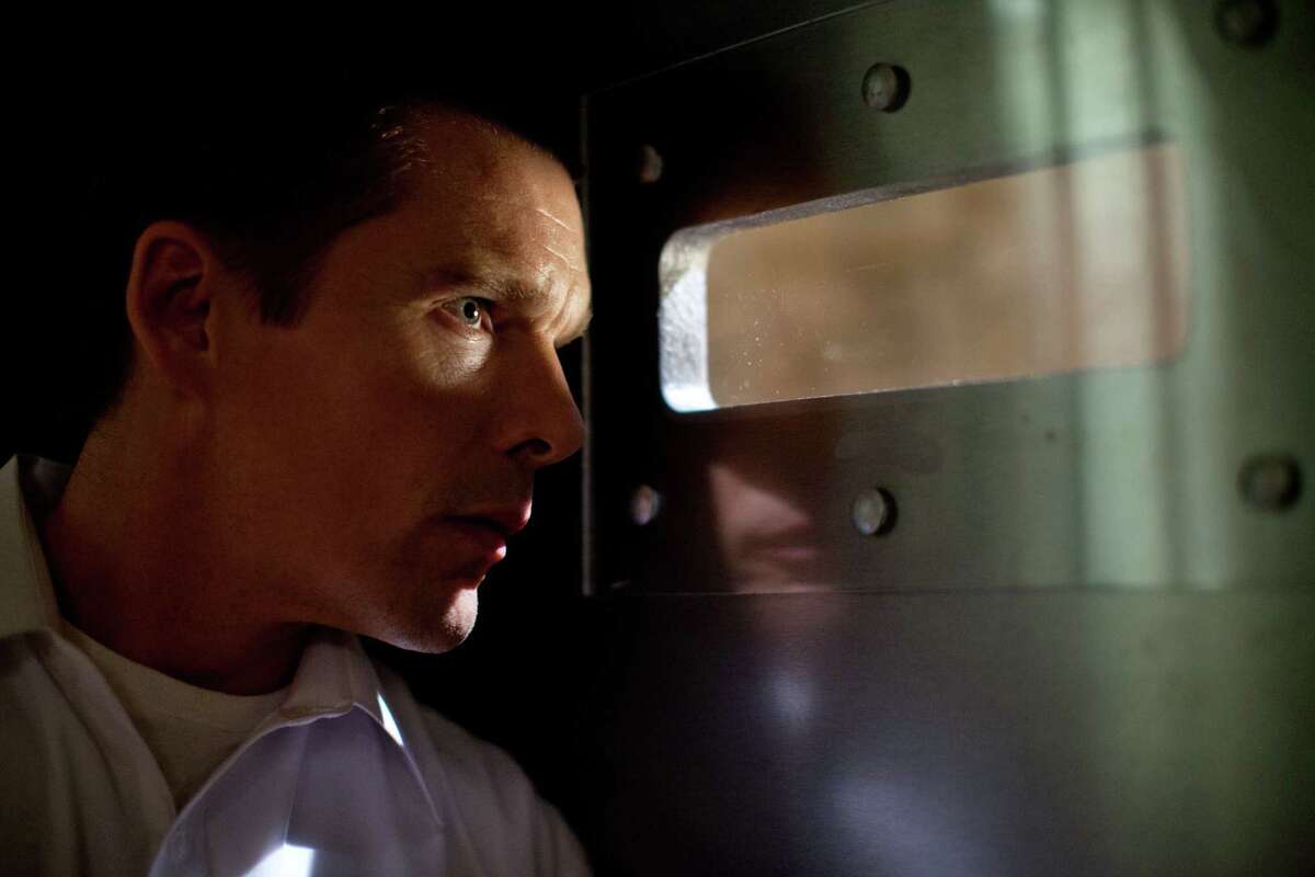 Ethan Hawke plays a security-conscious dad in the unusual thriller “The Purge.”