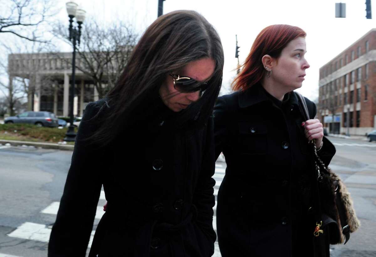 Nouel Alba, left, leaves the federal courthouse in Bridgeport, Conn. Thursday, Jan. 17, 2013 after pleading not guilty to scamming donors who wished to contribute to the funeral costs of Noah Pozner, a 6-year-old victim of the Newtown shooting.