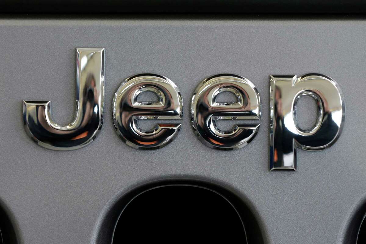 This Feb. 14, 2013 photo shows a Jeep logo on the grill of a Jeep Wrangler at the 2013 Pittsburgh Auto Show in Pittsburgh. Just two days after refusing a government request to recall 2.7 million older-model Jeeps, Chrysler has decided to do two other recalls totaling 630,000 vehicles worldwide, according to documents posted Thursday, June 6, 2013, on the National Highway Traffic Safety Administration website. The automaker will recall more than 409,000 Jeep Patriot and Compass small SUVs across the globe from the 2010 and 2012 model years to fix air bag and seat-belt problems. It's also recalling 221,000 Jeep Wranglers worldwide from 2012 and 2013 to fix transmission fluid leaks. (AP Photo/Gene J. Puskar)