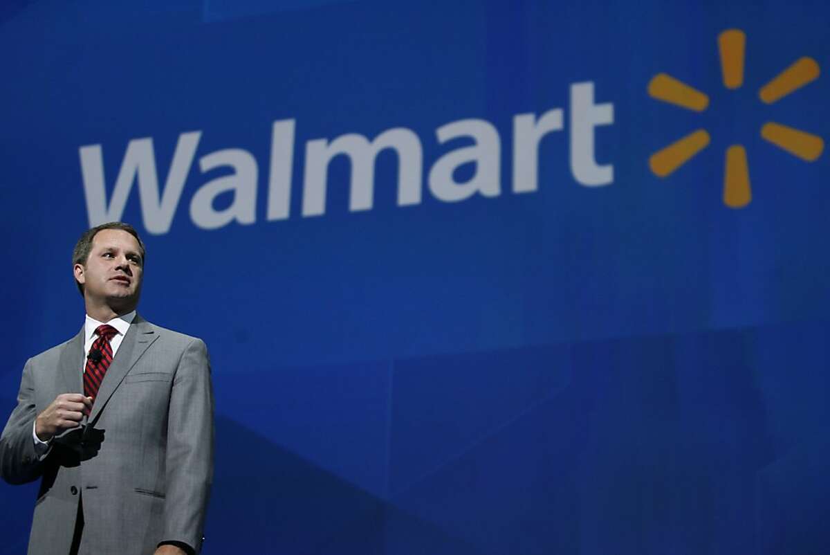 President and CEO, Walmart International Doug McMillan addresses the crowd on Wal-Mart's worldwide sales during the Walmart shareholders meeting in Fayetteville, Ark., Friday, June 7, 2013. (AP Photo/Gareth Patterson)