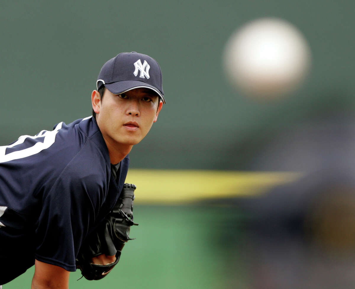 New York Yankees starting pitcher Chien-Ming Wang, of Taiwan, throws his warmup tosses from the mound before a baseball spring training game against the Philadelphia Phillies in Clearwater, Fla., Saturday, March 1, 2008. (AP Photo/Keith Srakocic)