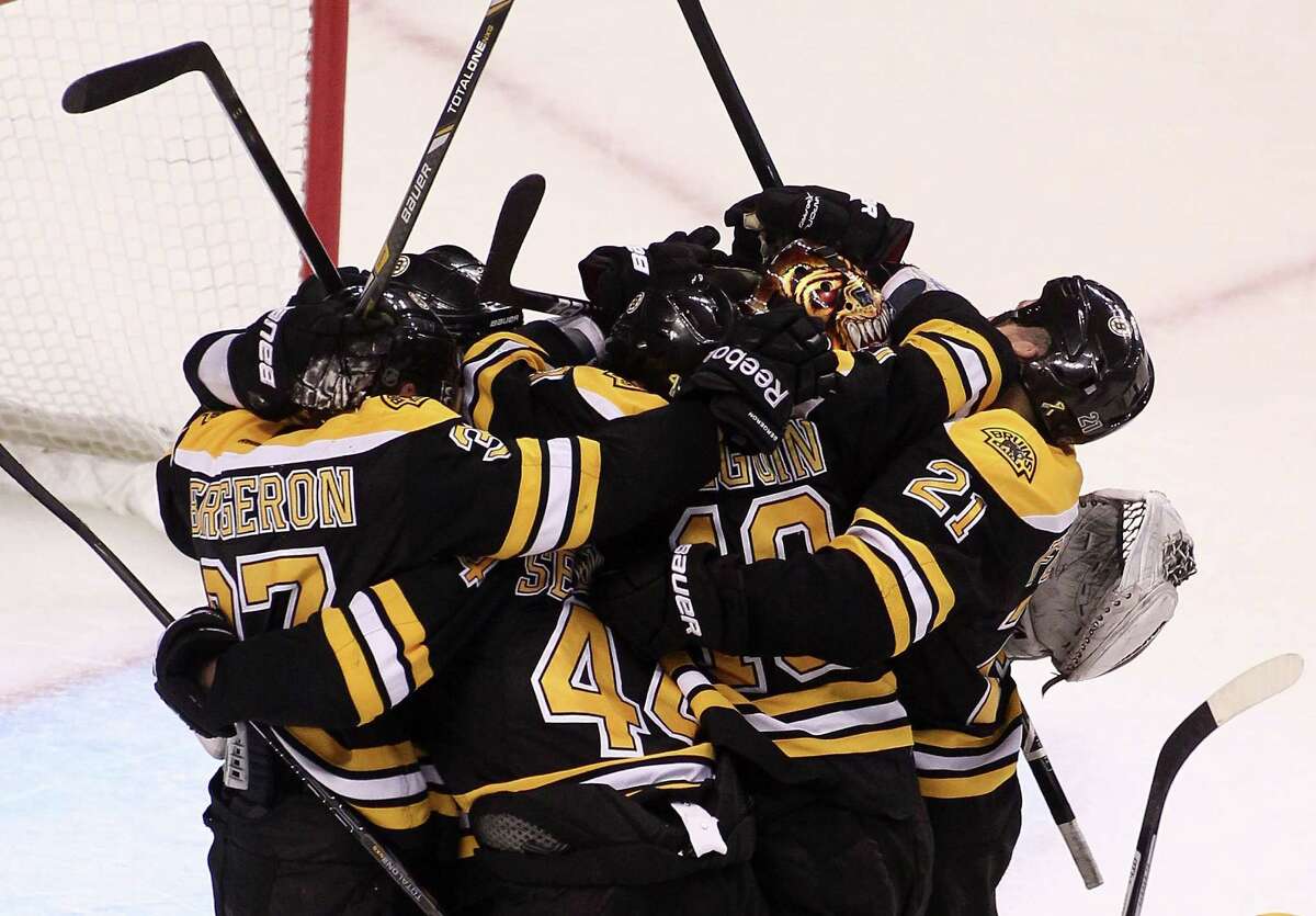 The Bruins celebrate winning a series in which they allowed only two goals to the Penguins.