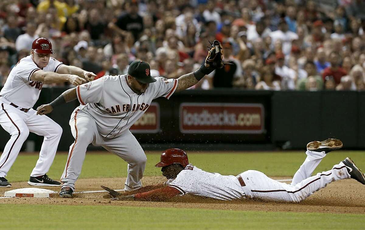 Giants Pablo Sandoval slides into third base in the fourth inning