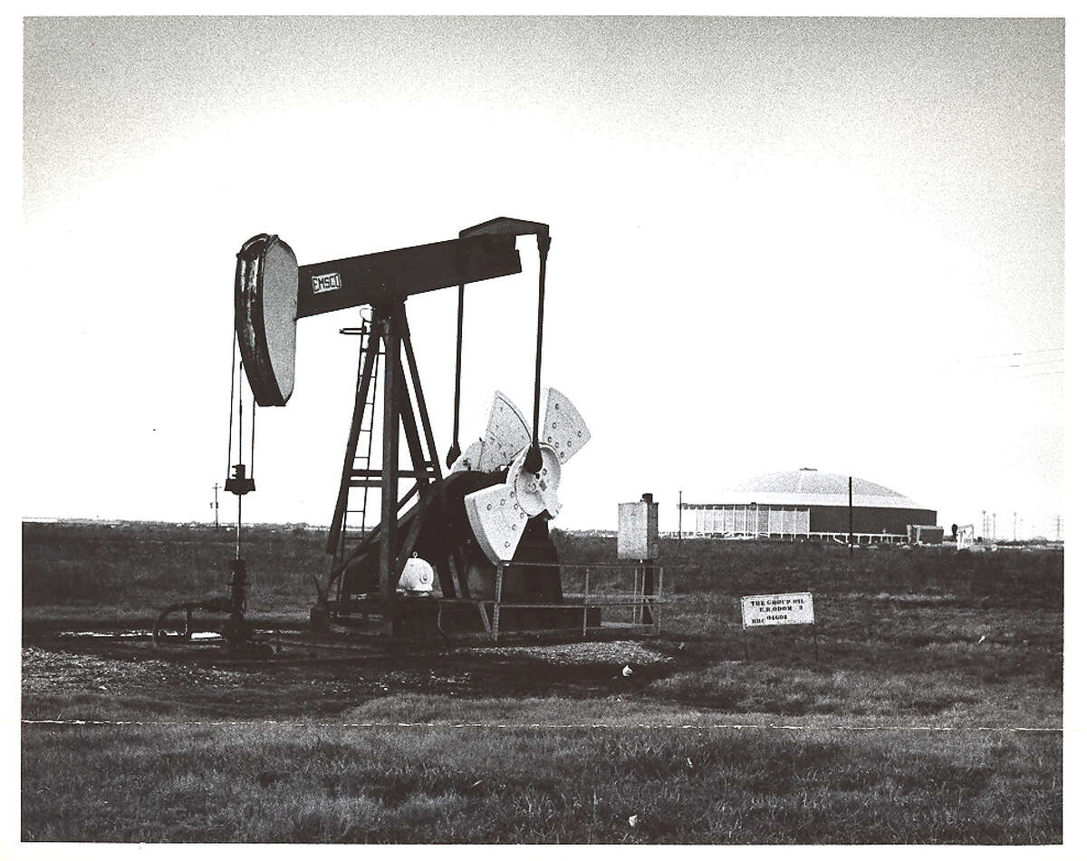 A pumpjack works in foreground of the Astrodome in 1965. For many, the two structures are iconic images of Houston.