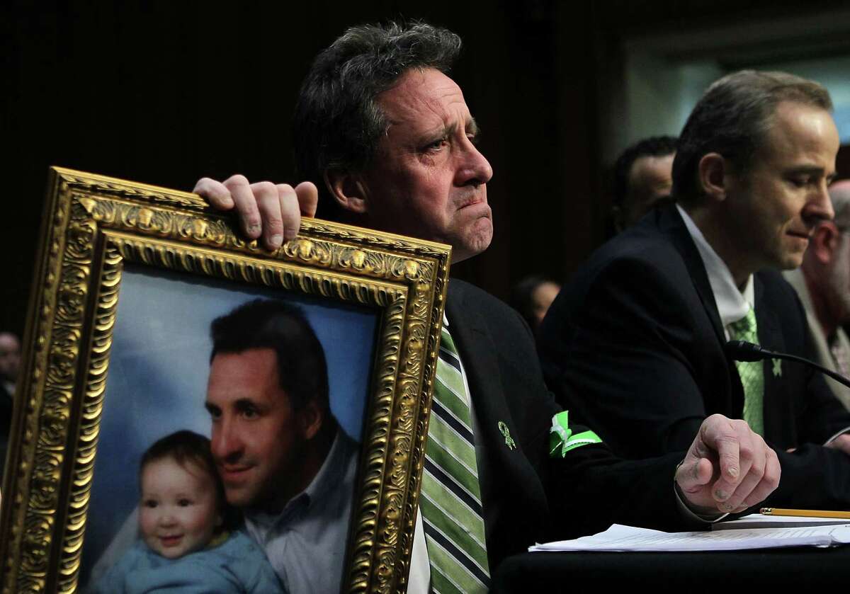 WASHINGTON, DC - FEBRUARY 27: Neil Heslin, father of six-year-old Sandy Hook Elementary School shooting victim Jesse Lewis, holds a picture of him with Jesse as he testifies during a hearing before the Senate Judiciary Committee February 27, 2013 on Capitol Hill in Washington, DC. The committee held a hearing on "The Assault Weapons Ban of 2013." EMS medical director of the Western Connecticut Health Network William Begg (R) also testified in the hearing. (Photo by Alex Wong/Getty Images)
