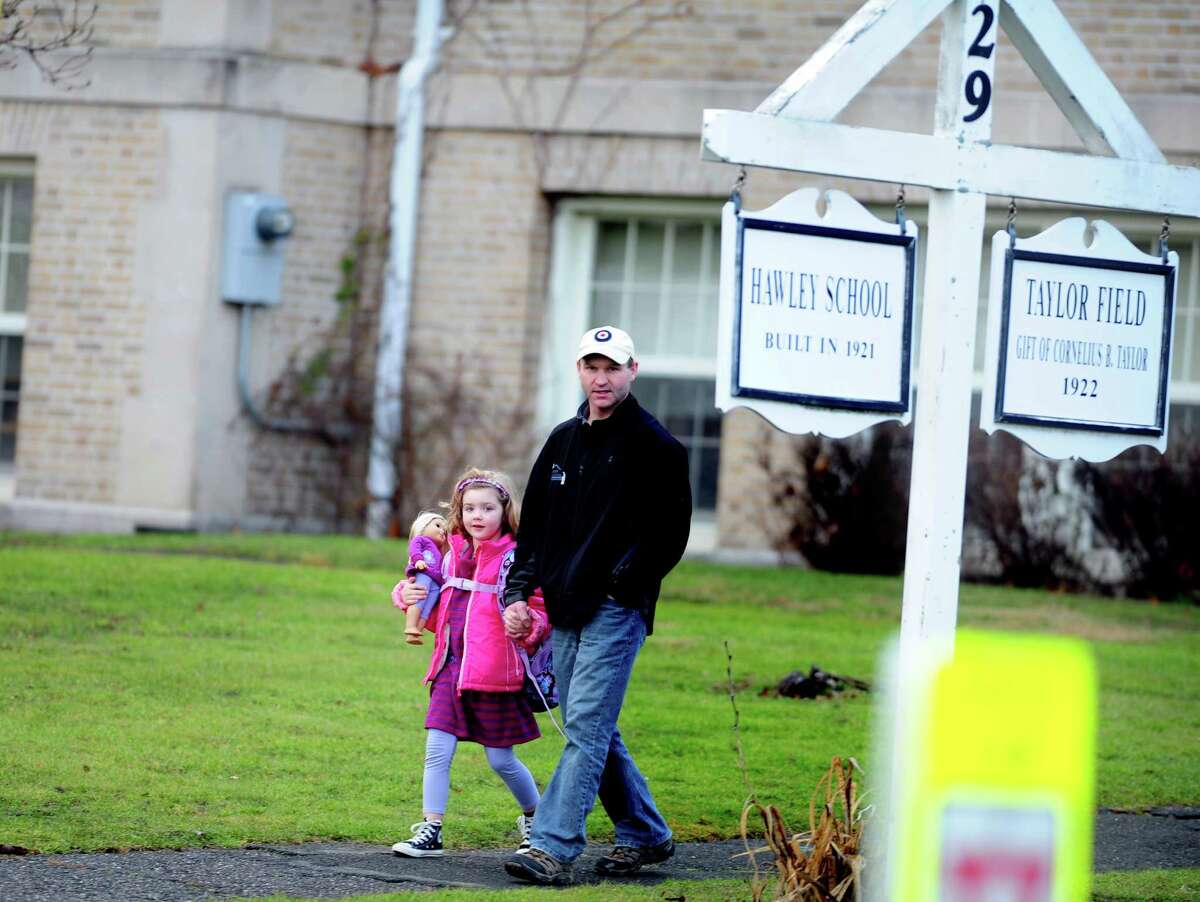 Children leave Hawley School in Newtown in this file photo from Dec. 18, 2012. On Monday afternoon, a telephone call to Hawley School that was deemed an implied threat led to the lockdown of all schools in town.