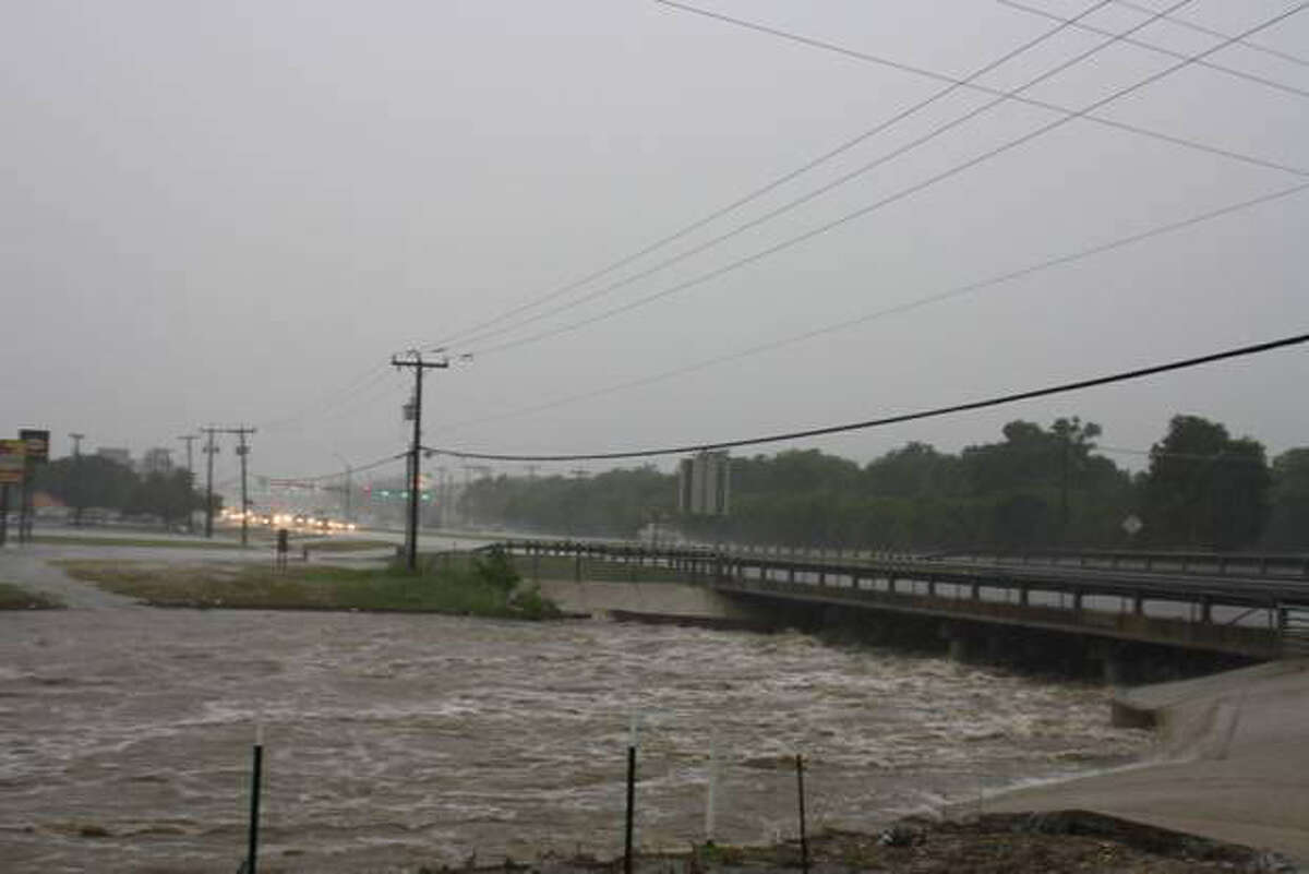 The Huebner Creek threatens to overflow its banks as it rushes under Bandera Road May 25 in Leon Valley.