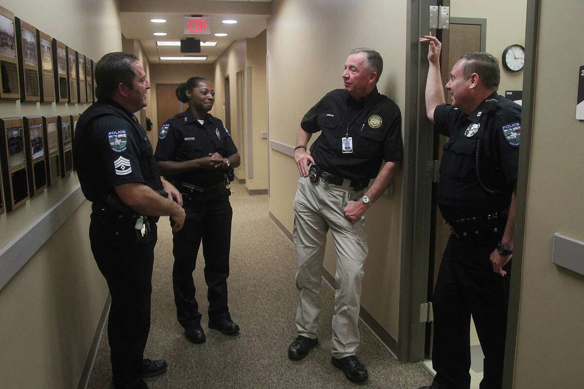 Pearland police lead chaplain Mike Waldrop, second from right, talks to officers on a regular basis. Here he talks with Sgt. Jon Matherne and Officers Zenaida Davis-Woods and Wes Boyer.